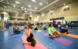 People do yoga in a gym