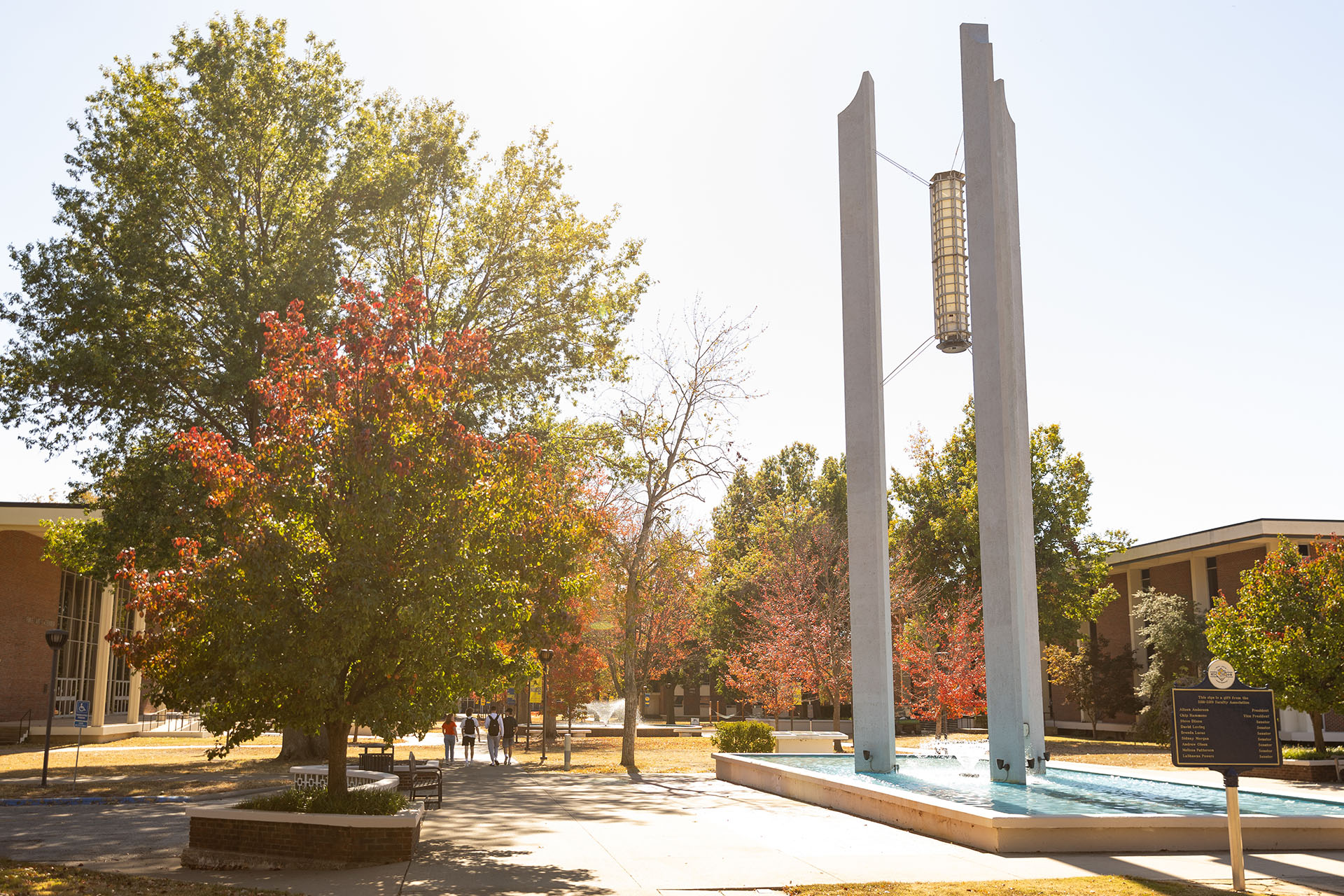 college campus with tall chimes monument in fall setting